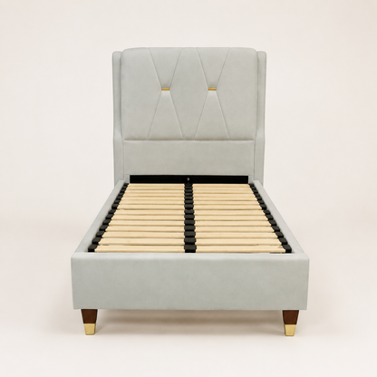 A light gray upholstered bed frame with a tall tufted headboard, wooden slats, and dark legs with gold-toned caps, shown against a plain light background.