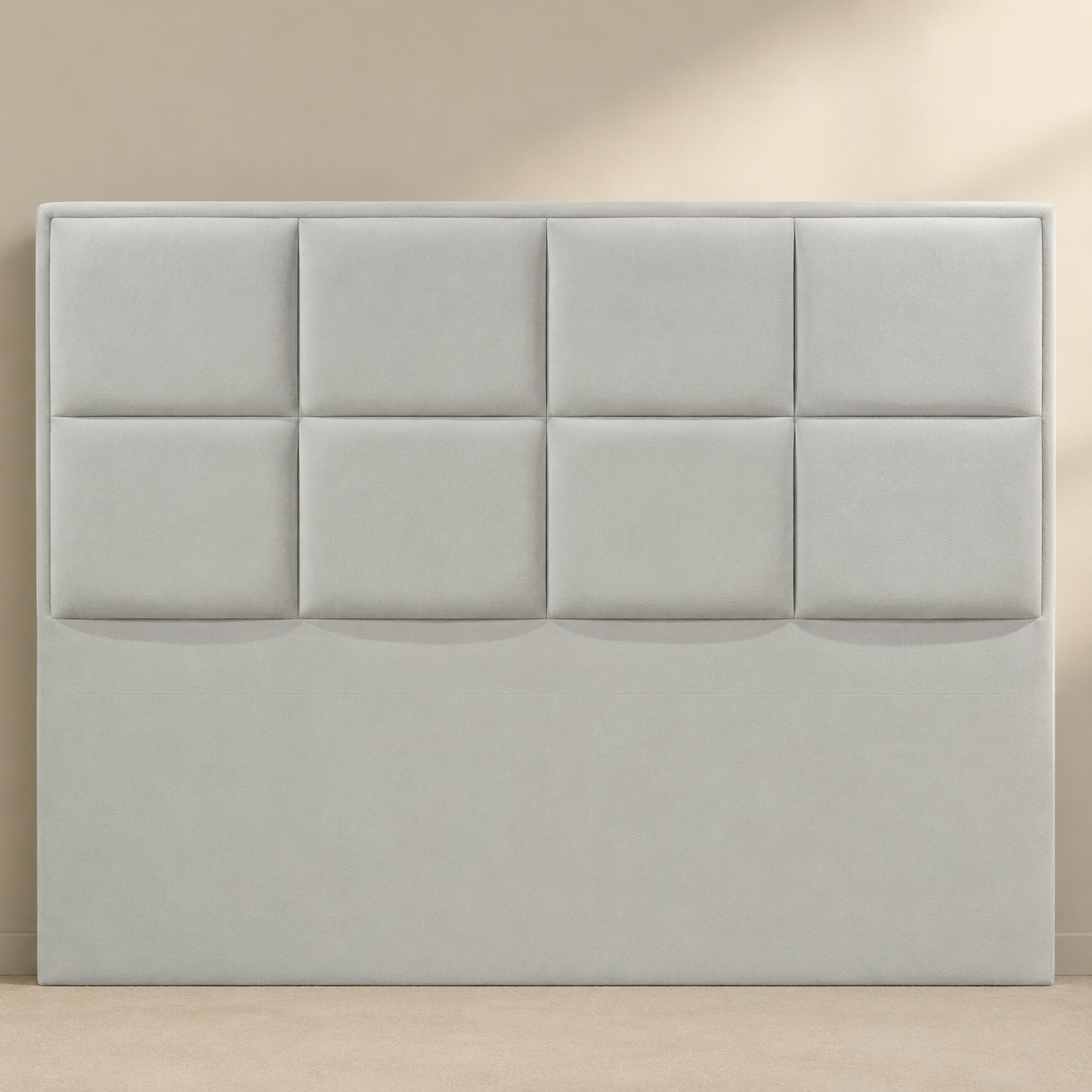 Close view of the AMYNA light grey suede headboard with eight broad padded panels