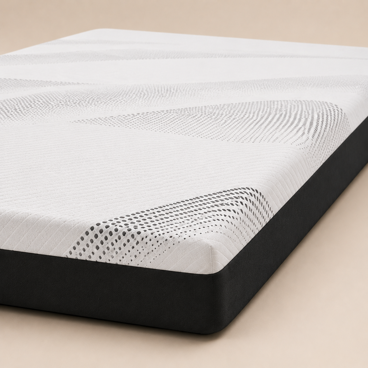 A close-up studio shot of a mattress corner showing a white textured top surface with a black side base on a warm beige background.